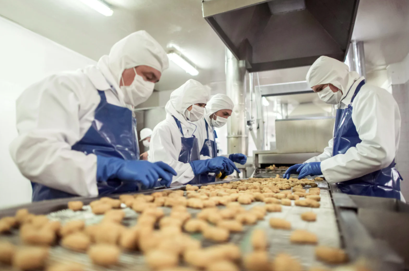 Food production line workers — one of the industries we serve daily